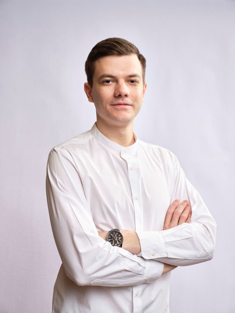 George smiling with arms crossed
